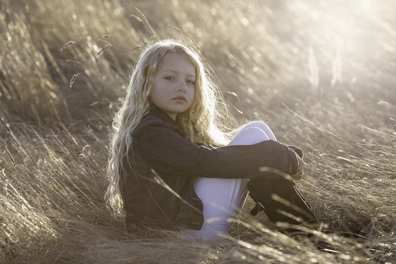 Blond hair child in a gold-colored field.